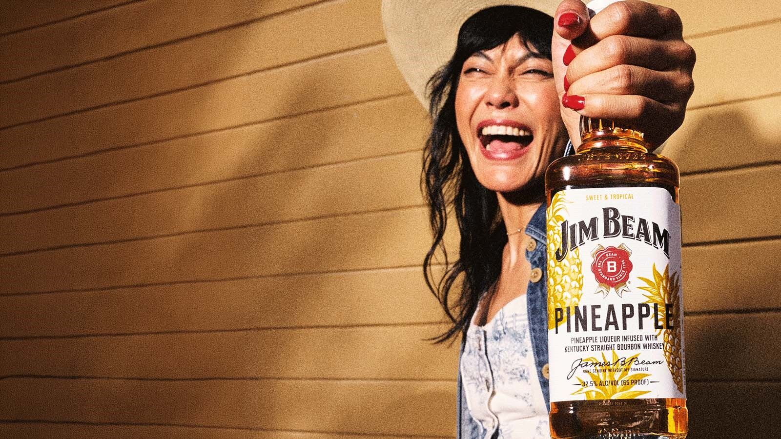 Woman Holding Pineapple Bourbon Bottle Outdoor Celebration Smile Jim Beam
