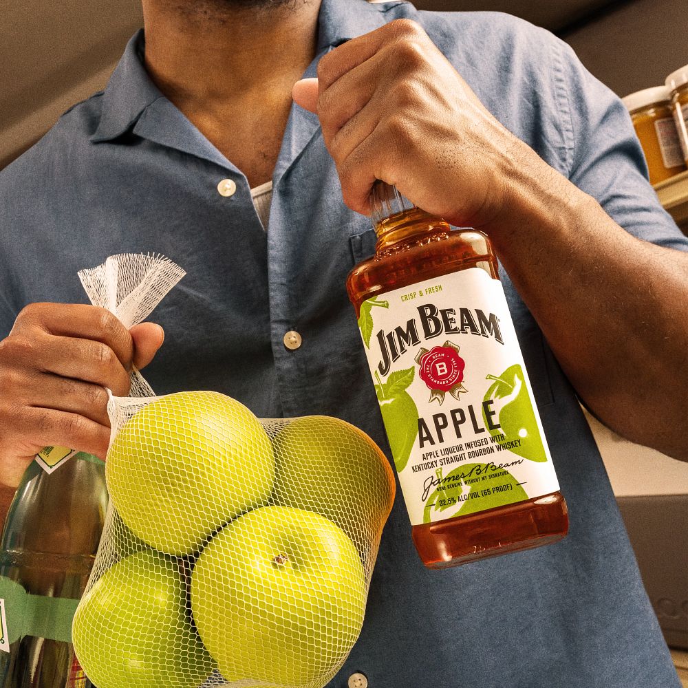 Person Holding Jim Beam Apple Bottle Fresh Apples Grocery Setting Jim Beam
