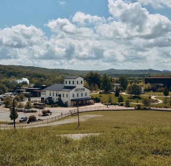 Distillery Campus White Building Rolling Hills Blue Sky Jim Beam