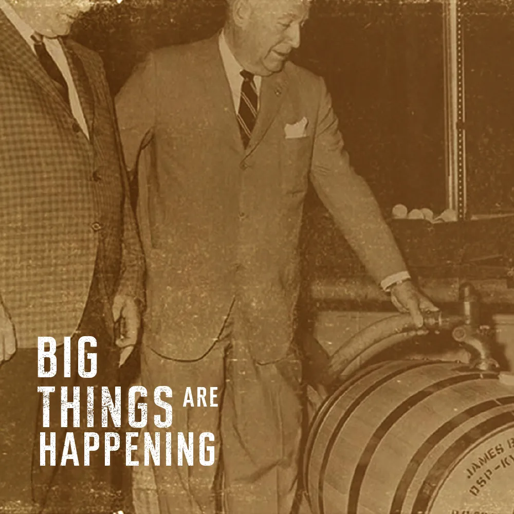 Two men filling Jim Beam Barrel