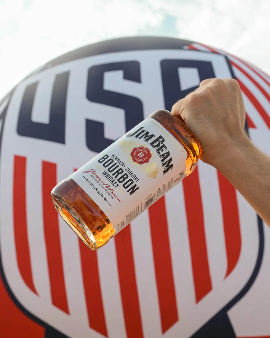 Jim Beam Block Party bottle and a big logo background