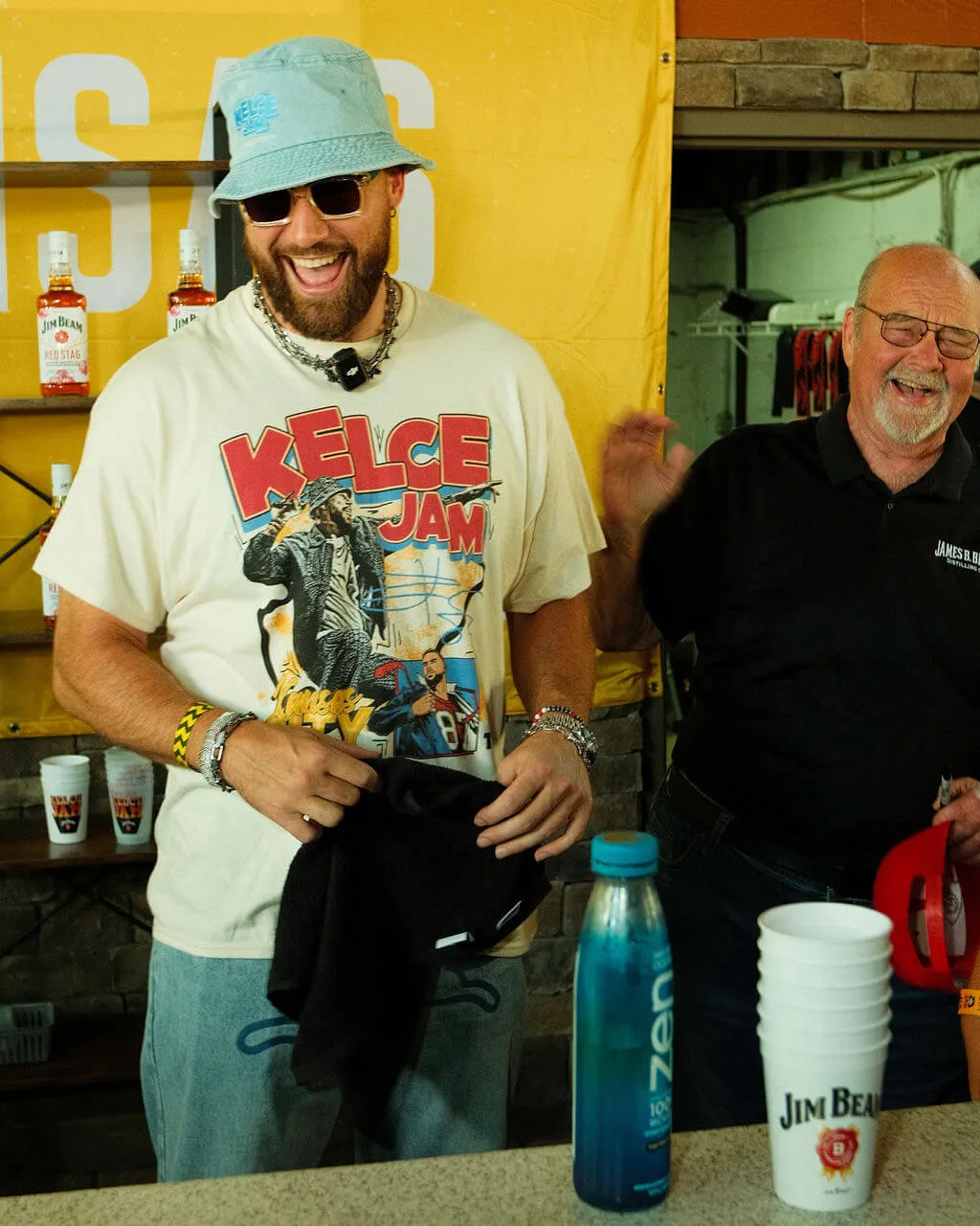 Travis Kelce and Fred Booker Noe laughing during the Kelce Jam 2024 festival