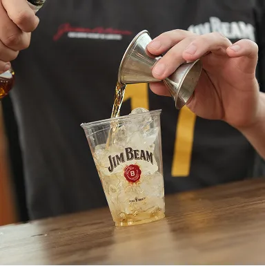 Pouring Bourbon Into Ice Cup Jim Beam