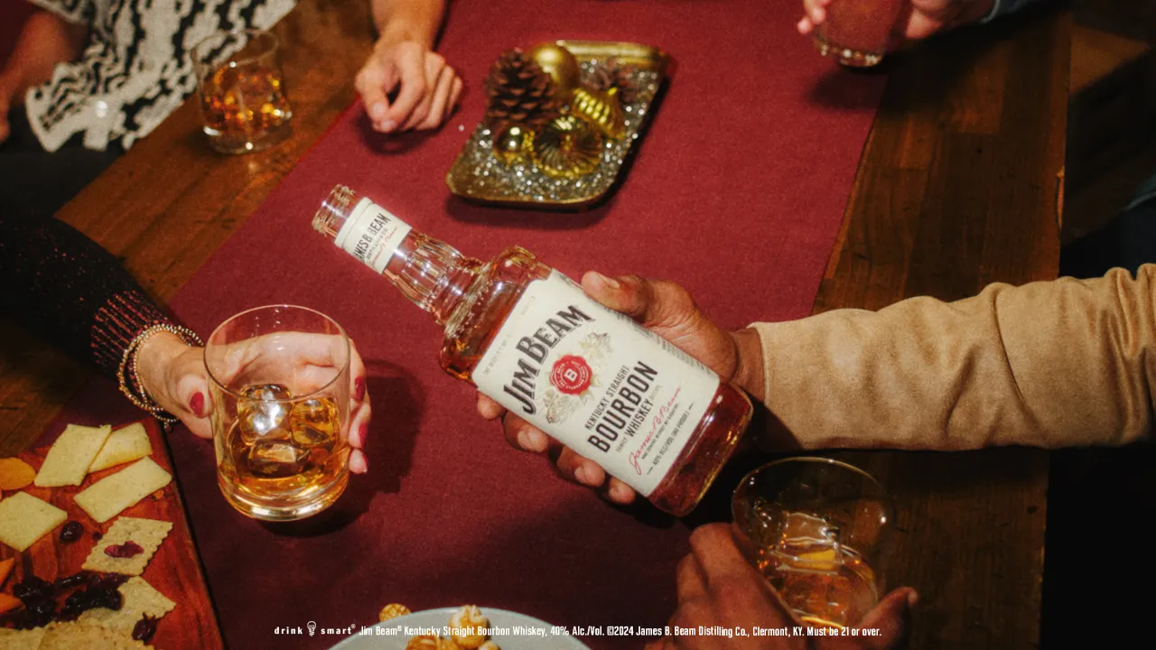 Jim Beam whisky bottle in hand