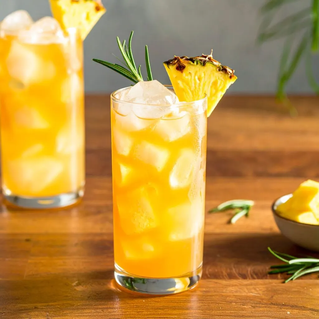 Pineapple Bourbon Iced Tea glasses decorated with pineapple at edges