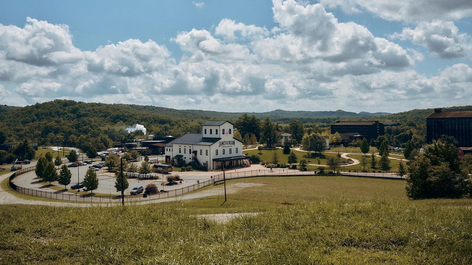 Distillery Campus White Building Rolling Hills Blue Sky Jim Beam