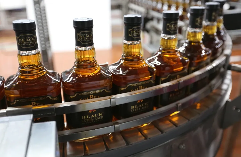 Bottles of Jim Beam Black Extra Aged Bourbon moving along a bottling line at the distillery.